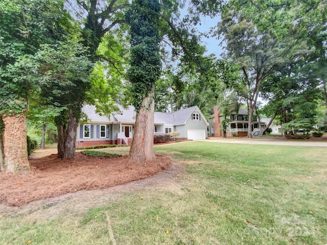 single story home featuring a front lawn and a garage
