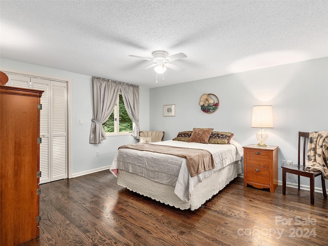 bedroom with a closet, ceiling fan, dark hardwood / wood-style flooring, and a textured ceiling