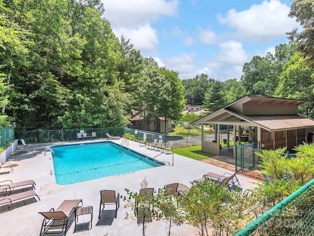 view of swimming pool with a patio