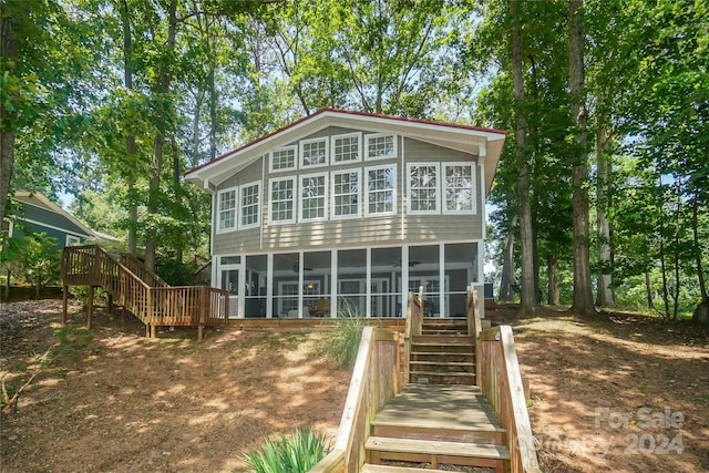 back of property featuring a sunroom