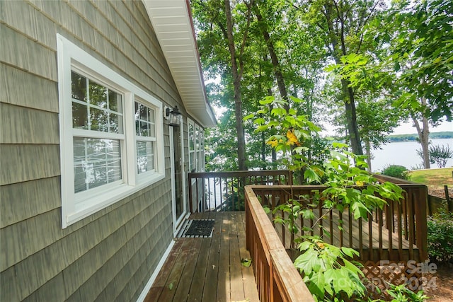 wooden terrace featuring a water view