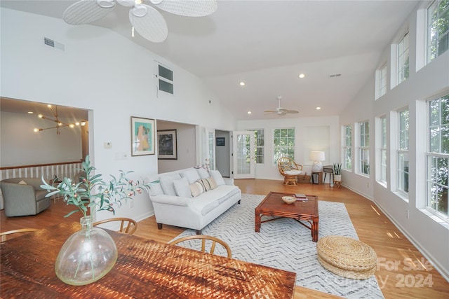 living room featuring light wood-type flooring, ceiling fan, and high vaulted ceiling