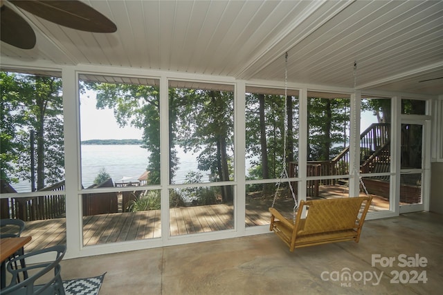 sunroom / solarium featuring a water view