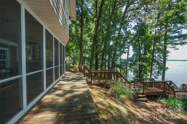 wooden deck with a water view and a sunroom