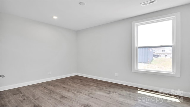 unfurnished room with plenty of natural light and wood-type flooring