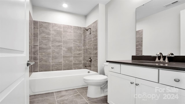 full bathroom with vanity, toilet, and tiled shower / bath