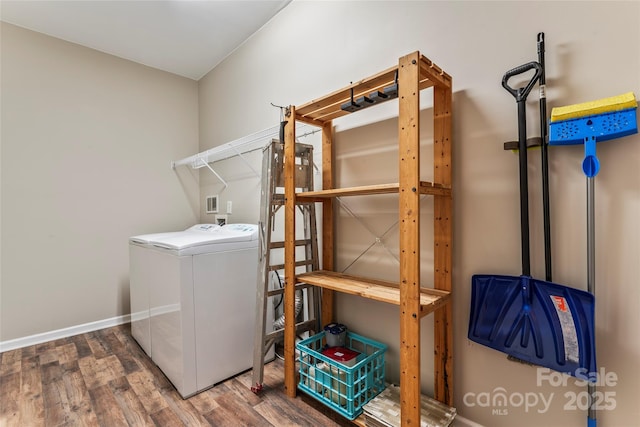 clothes washing area featuring washer / clothes dryer and hardwood / wood-style flooring