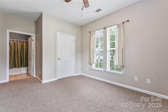 unfurnished bedroom with carpet flooring, ensuite bathroom, and ceiling fan