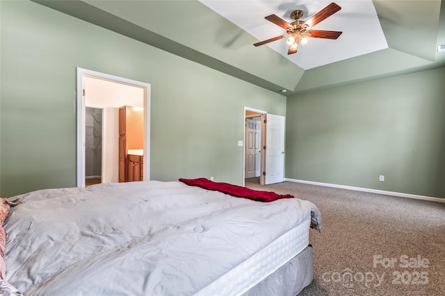 carpeted bedroom with a tray ceiling, ceiling fan, a closet, and a spacious closet