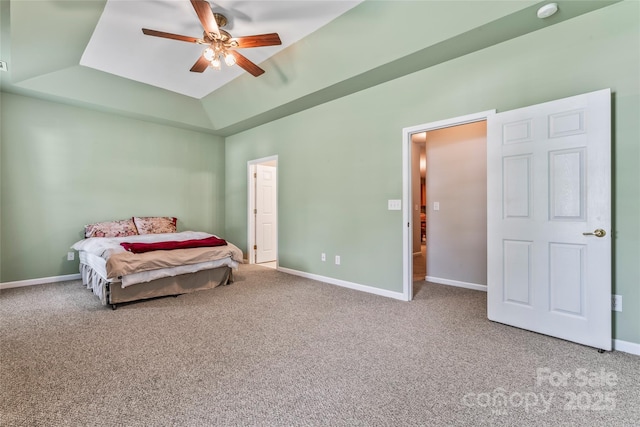 bedroom with a raised ceiling, ceiling fan, carpet floors, and vaulted ceiling