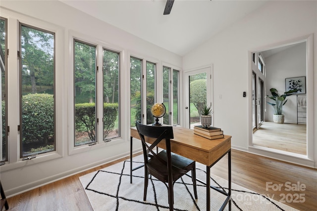 office space with ceiling fan, light hardwood / wood-style flooring, and vaulted ceiling