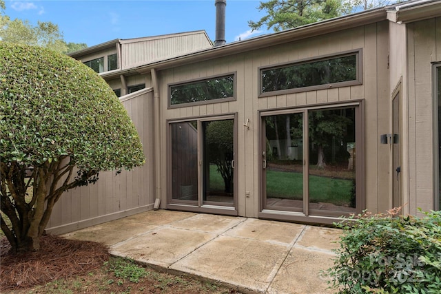 view of exterior entry with a patio