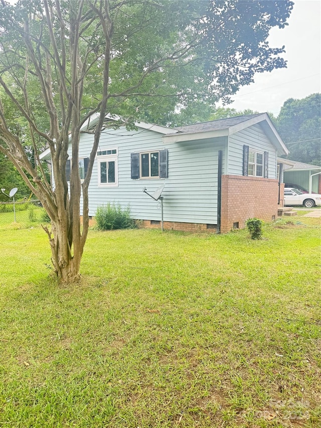 view of property exterior with a lawn