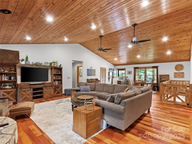 living room featuring wood ceiling, ceiling fan, light hardwood / wood-style floors, and vaulted ceiling