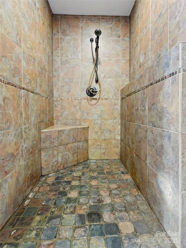 bathroom with tiled shower