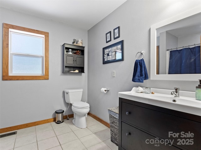 bathroom featuring tile patterned floors, vanity, and toilet