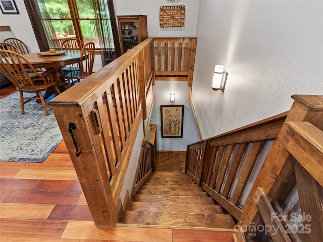 stairway with hardwood / wood-style floors