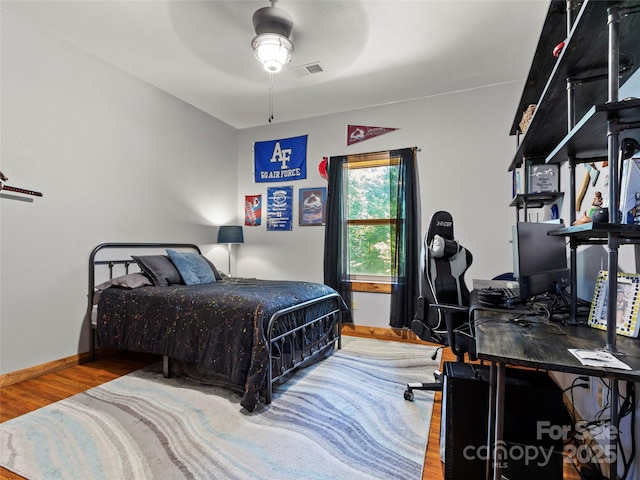 bedroom with wood-type flooring and ceiling fan