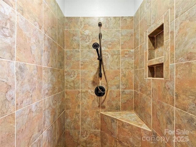 interior details with a tile shower