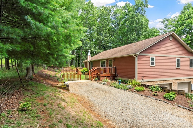 view of home's exterior with a deck and a garage