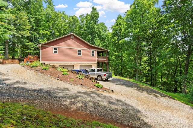 view of property exterior featuring a garage and a deck