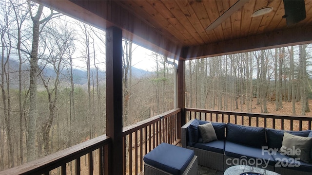 wooden deck featuring ceiling fan