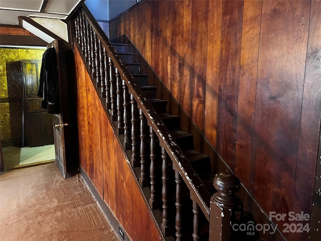 stairway with wood walls