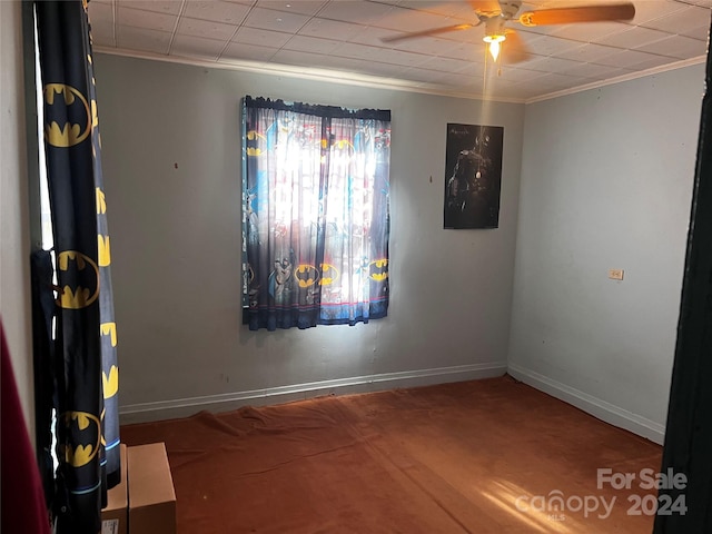 spare room with ceiling fan and ornamental molding