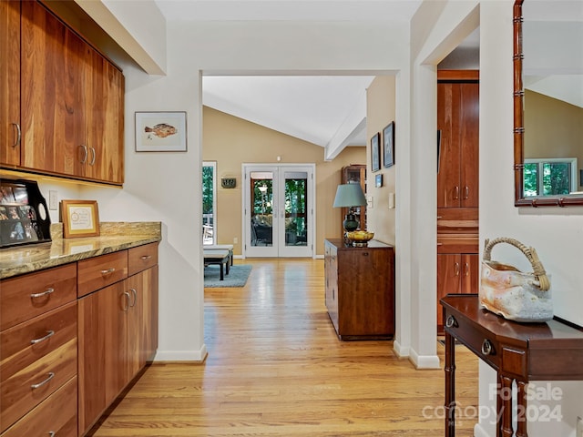 kitchen with lofted ceiling with beams, french doors, light hardwood / wood-style flooring, and a wealth of natural light