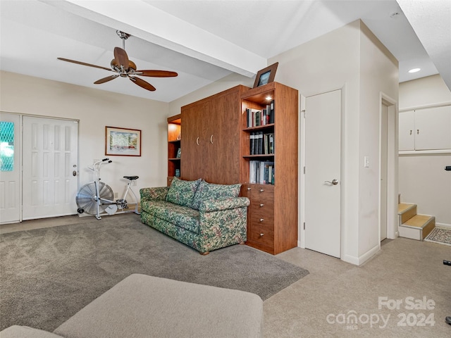 carpeted living room featuring beam ceiling and ceiling fan