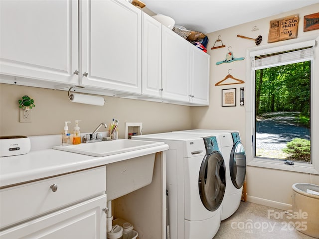 laundry room featuring cabinets and washer and dryer