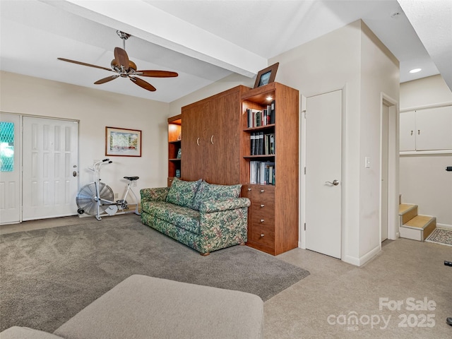 carpeted living room with beam ceiling and ceiling fan