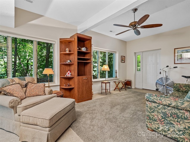 living room featuring light carpet, ceiling fan, and beamed ceiling