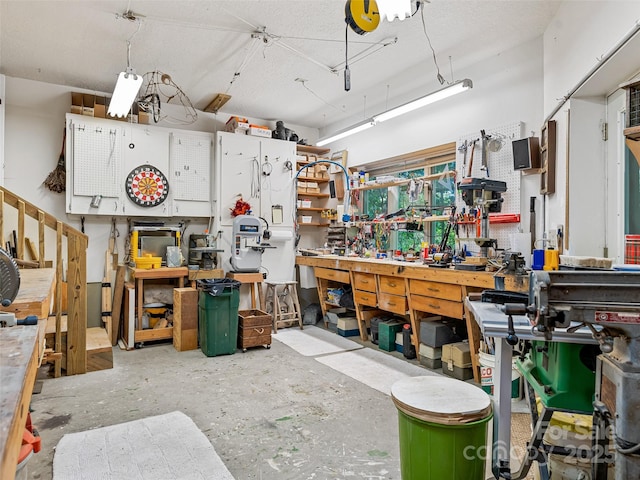 miscellaneous room with concrete floors and a workshop area