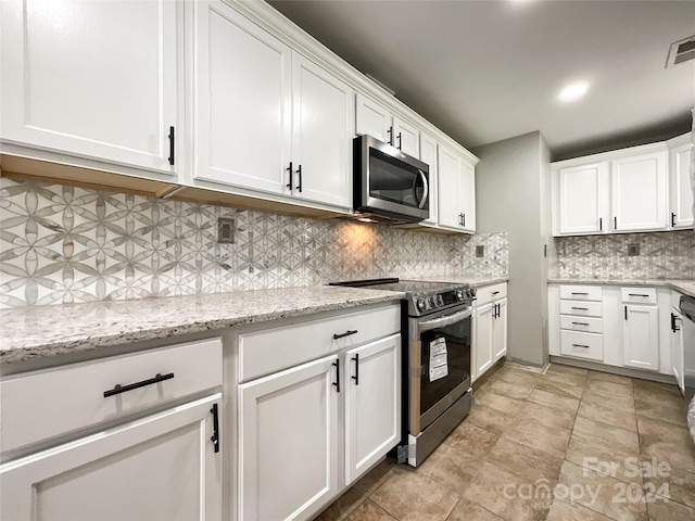 kitchen featuring white cabinets, backsplash, stainless steel appliances, and light stone counters