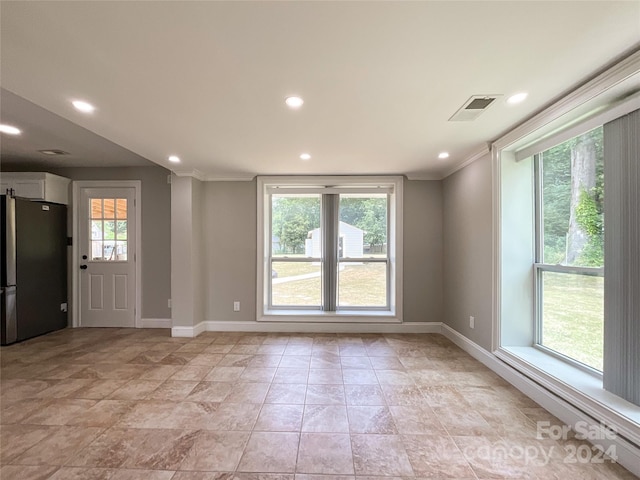 empty room featuring crown molding