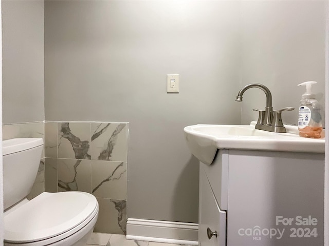 bathroom with tile patterned floors, vanity, and toilet