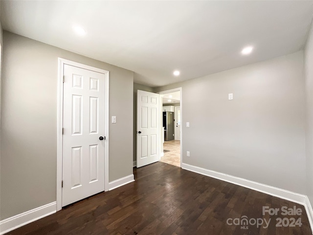 empty room featuring dark wood-type flooring