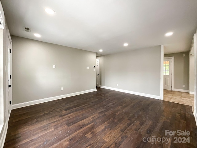 spare room featuring dark hardwood / wood-style flooring