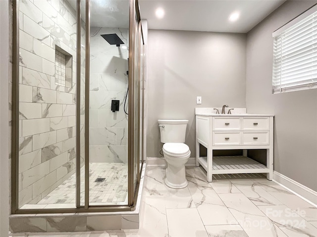 bathroom with vanity, toilet, and a shower with shower door