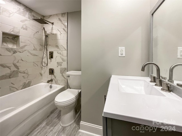 full bathroom featuring toilet, vanity, tiled shower / bath combo, and hardwood / wood-style flooring