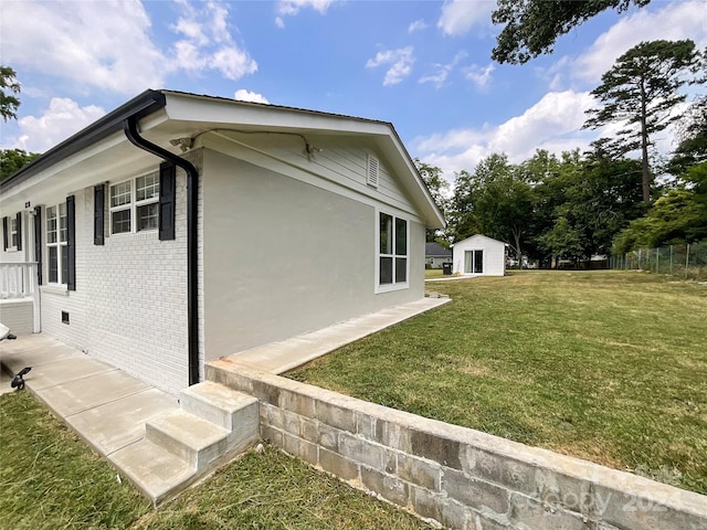 view of property exterior with a lawn and an outbuilding