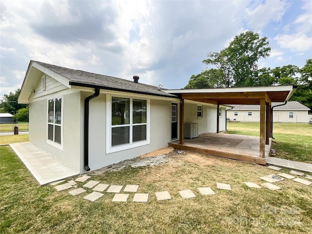 exterior space with a patio, central AC unit, and a front lawn