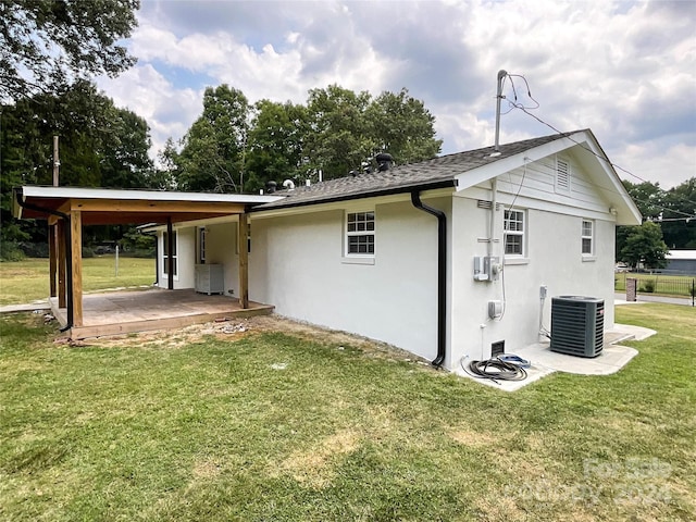 rear view of house featuring a yard, a patio, and central AC