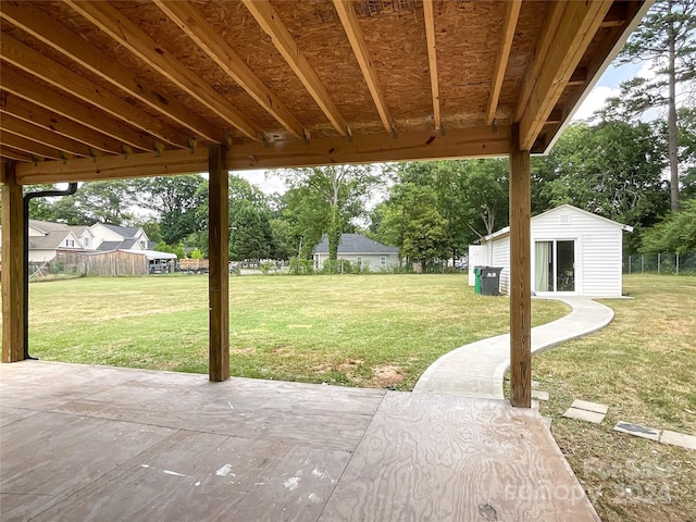 view of patio with an outbuilding