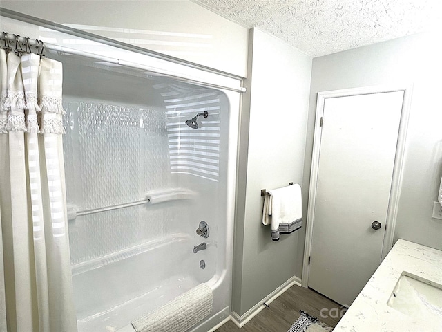 bathroom featuring a textured ceiling, shower / tub combination, vanity, and hardwood / wood-style floors