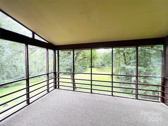 unfurnished sunroom featuring vaulted ceiling