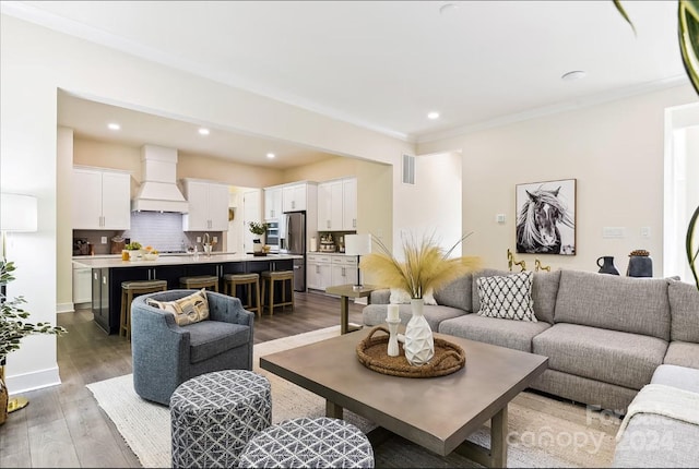 living room featuring crown molding and hardwood / wood-style flooring