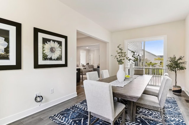 dining space with dark wood-type flooring