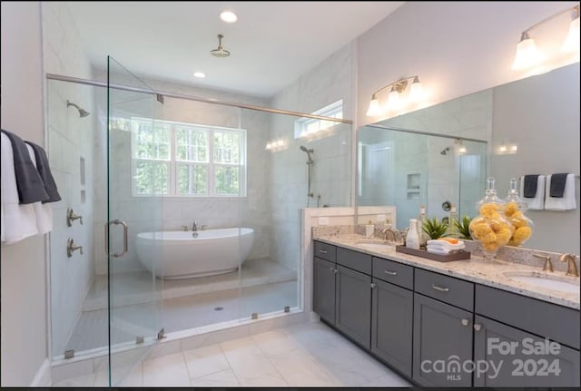 bathroom featuring independent shower and bath, tile patterned flooring, and vanity